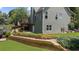 Rear exterior with multi-tiered landscaping and grass lawn at 307 Cabinwood Trl, Canton, GA 30115