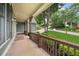 A charming front porch featuring wood columns and railings with a view of the landscaped front yard at 307 Cabinwood Trl, Canton, GA 30115