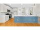 Bright kitchen features a large island, stainless steel appliances, white cabinetry, and hardwood floors at 307 Cabinwood Trl, Canton, GA 30115