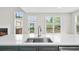 Kitchen island featuring a stainless steel sink, faucet, and quartz countertop with a fireplace in the background at 307 Cabinwood Trl, Canton, GA 30115