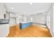 Open kitchen with white cabinetry, a central island, and hardwood floors at 307 Cabinwood Trl, Canton, GA 30115
