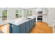 Open concept kitchen featuring a large island with seating and stainless steel appliances and a double-door that leads to a deck at 307 Cabinwood Trl, Canton, GA 30115