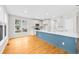 Bright kitchen with white cabinets, an island with a blue base, hardwood floors and stainless steel appliances at 307 Cabinwood Trl, Canton, GA 30115