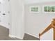 Carpeted staircase with wood railing and wainscotting detail on walls and a double door closet at 307 Cabinwood Trl, Canton, GA 30115