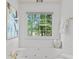 Bright bathroom featuring a large soaking tub with jets and a large window for great light at 3242 Monarch Pine Dr, Peachtree Corners, GA 30071