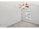 Bright bedroom features a ceiling fan, a large window, and neutral decor at 3242 Monarch Pine Dr, Peachtree Corners, GA 30071