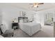 Bright bedroom features a ceiling fan, tray ceiling, and neutral decor, with an attached sitting room at 3242 Monarch Pine Dr, Peachtree Corners, GA 30071
