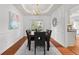 Bright and elegant dining room with tray ceiling, chandelier, and hardwood floors at 3242 Monarch Pine Dr, Peachtree Corners, GA 30071