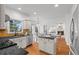 Open kitchen with granite counters, stainless appliances, island, and adjacent breakfast nook and living room at 3242 Monarch Pine Dr, Peachtree Corners, GA 30071