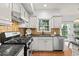 Beautiful kitchen with white cabinets, granite countertops, stainless steel appliances, and a window over the sink at 3242 Monarch Pine Dr, Peachtree Corners, GA 30071