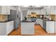 Well-equipped kitchen featuring white cabinets, granite countertops, stainless steel appliances, and an island at 3242 Monarch Pine Dr, Peachtree Corners, GA 30071