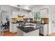 Bright kitchen with granite countertops, center island, stainless steel appliances, and tiled backsplash at 3242 Monarch Pine Dr, Peachtree Corners, GA 30071