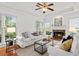 Cozy living room with fireplace, hardwood floors, tray ceilings, and large windows at 3242 Monarch Pine Dr, Peachtree Corners, GA 30071