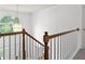 Grand stairway with wooden handrail, white spindles, and chandelier above front entry at 3242 Monarch Pine Dr, Peachtree Corners, GA 30071