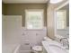 Bright bathroom featuring a white tile surround, classic fixtures, and a marble vanity at 4447 Ben Hill Rd, Lithia Springs, GA 30122