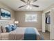 Inviting bedroom with a closet, ceiling fan and comfortable bed dressed with blue pillows at 4447 Ben Hill Rd, Lithia Springs, GA 30122