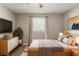 Cozy bedroom featuring neutral tones, comfortable bedding, and natural light from the window at 4447 Ben Hill Rd, Lithia Springs, GA 30122