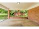 Spacious brick carport with concrete floor at 4447 Ben Hill Rd, Lithia Springs, GA 30122