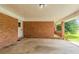 Spacious brick carport features an entrance door at 4447 Ben Hill Rd, Lithia Springs, GA 30122