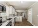 Bright, updated kitchen with stainless steel appliances, white cabinetry and eat-in counter at 4447 Ben Hill Rd, Lithia Springs, GA 30122