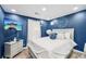 Bedroom with a decorative blue wall, a TV, and light gray furniture at 4467 Pineridge Cir, Atlanta, GA 30338