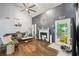 Bright living room with hardwood floors, vaulted ceiling, fireplace, and access to a screened porch at 4467 Pineridge Cir, Atlanta, GA 30338