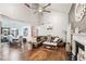 Open-concept living area with hardwood floors, high ceilings, fireplace, and a view of the dining area at 4467 Pineridge Cir, Atlanta, GA 30338