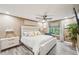 Calming primary bedroom features a plush bed, neutral decor, a ceiling fan, and a bright window at 4467 Pineridge Cir, Atlanta, GA 30338