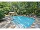 Refreshing community pool with sun loungers and a charming pool house surrounded by lush greenery at 4467 Pineridge Cir, Atlanta, GA 30338