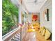 Cozy screened porch with natural light, serene wooded view, and colorful yellow decor at 4467 Pineridge Cir, Atlanta, GA 30338