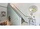 Stylish staircase featuring modern railings, grey trim, and an elegant decorative mirror at 4467 Pineridge Cir, Atlanta, GA 30338