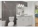 Bathroom features modern vanity with vessel sink, and tiled shower and accent wall at 950 Nw W Peachtree Nw St # 410, Atlanta, GA 30309