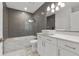 Bathroom features modern vanity, vessel sink, sleek lighting, and tiled shower-tub combo at 950 Nw W Peachtree Nw St # 410, Atlanta, GA 30309