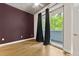 Bedroom with hardwood floors, modern ceiling fan, and sliding glass doors to a balcony at 950 Nw W Peachtree Nw St # 410, Atlanta, GA 30309