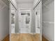 Walk-in closet featuring mirrored sliding doors and wire shelving, with ensuite bathroom at 950 Nw W Peachtree Nw St # 410, Atlanta, GA 30309