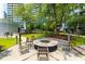 A beautifully landscaped common area with a fire pit and outdoor grills offer residents the opportunity to gather and relax at 950 Nw W Peachtree Nw St # 410, Atlanta, GA 30309