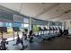 Well-lit gym with floor-to-ceiling windows and state-of-the-art cardio equipment at 950 Nw W Peachtree Nw St # 410, Atlanta, GA 30309