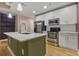 Modern kitchen features an island, stainless steel appliances, and white cabinets at 950 Nw W Peachtree Nw St # 410, Atlanta, GA 30309
