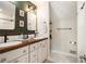 Bathroom with dual sinks, wood counters, and modern fixtures at 1175 Haven Brook Way, Atlanta, GA 30319