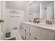 Bright bathroom featuring a double sink vanity, framed mirror, and a tiled shower with glass door at 1175 Haven Brook Way, Atlanta, GA 30319