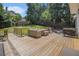 Spacious wooden deck with outdoor furniture, grill, and a manicured lawn in the backyard at 1175 Haven Brook Way, Atlanta, GA 30319