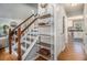 Hallway with wood floors and open staircase to kitchen and fireplace visible at 1175 Haven Brook Way, Atlanta, GA 30319