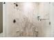 Shower with marble-look tile and built-in corner shelves at 1175 Haven Brook Way, Atlanta, GA 30319