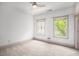 Clean, empty bedroom featuring two windows, neutral carpeting, and a ceiling fan at 1216 Virginia Ne Ct # 8, Atlanta, GA 30306
