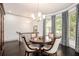 Bright dining room features dark wood floors, modern chandelier, and large windows with decorative curtains at 1216 Virginia Ne Ct # 8, Atlanta, GA 30306