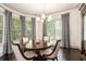 Bright dining area with a round wood table, seating for four, large windows and stylish patterned curtains at 1216 Virginia Ne Ct # 8, Atlanta, GA 30306