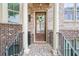 Inviting front entrance with brick columns, wooden door with glass, and stylish wreath at 1216 Virginia Ne Ct # 8, Atlanta, GA 30306