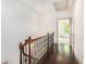 Hallway with hardwood floors and wrought iron railing leading to a bedroom at 1216 Virginia Ne Ct # 8, Atlanta, GA 30306