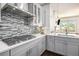 Stylish gray and white kitchen features stainless steel appliances and modern backsplash at 1216 Virginia Ne Ct # 8, Atlanta, GA 30306