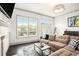 Cozy living room with a fireplace, a comfortable sofa, and a large window for natural light at 1216 Virginia Ne Ct # 8, Atlanta, GA 30306